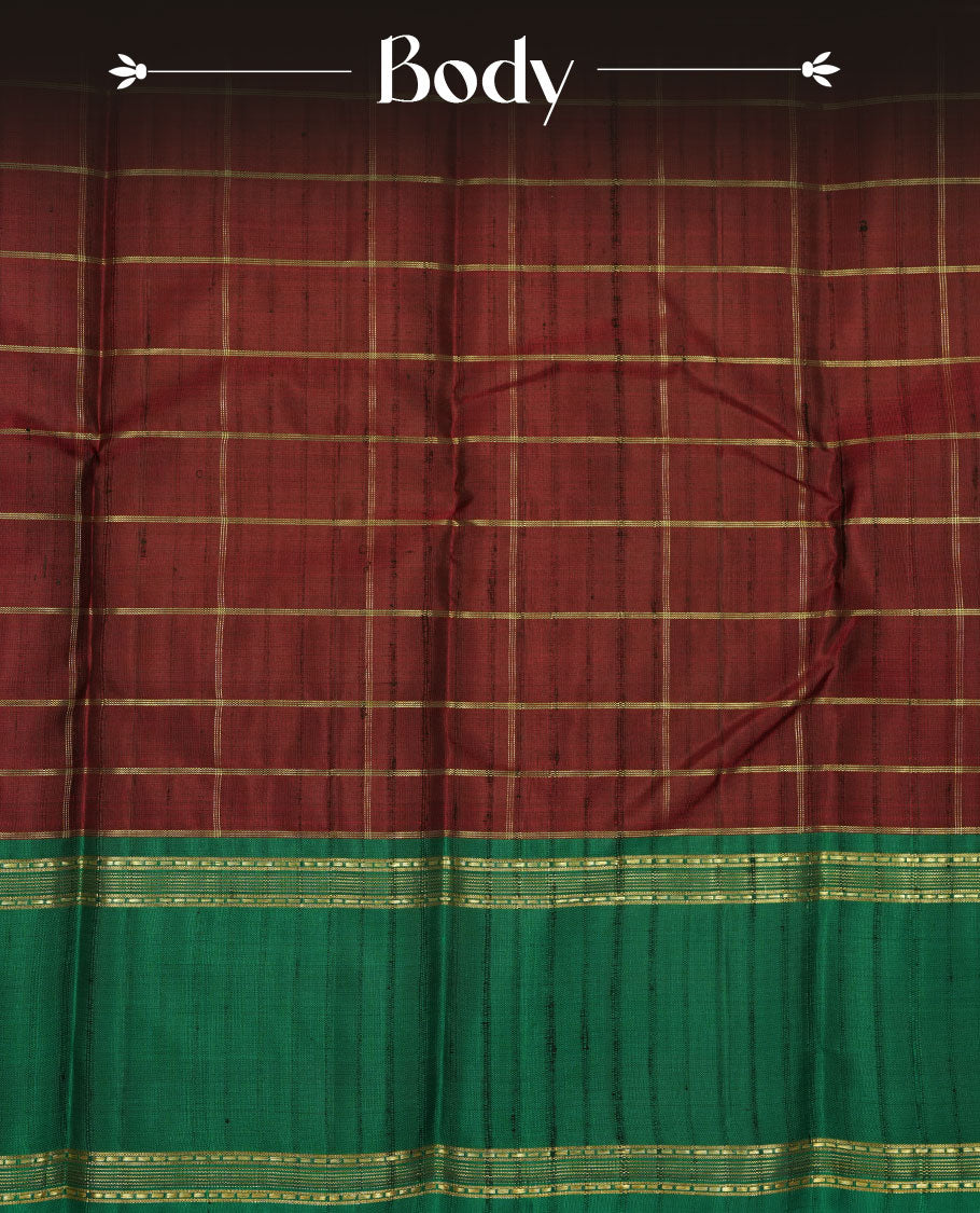 Maroon colour pure traditional Kancheepuram silk saree adorned with an elegant zari check pattern across the body, complemented by a contrast zari woven border, paired with a matching blouse piece.