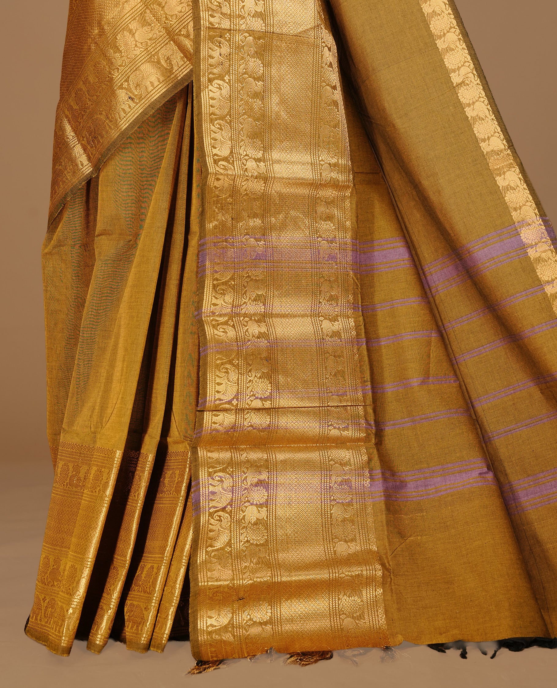Warm Olive Colour chettinad cotton saree featuring Elegant plain body, complemented by self colour with gold zari border, paired with matching blouse.