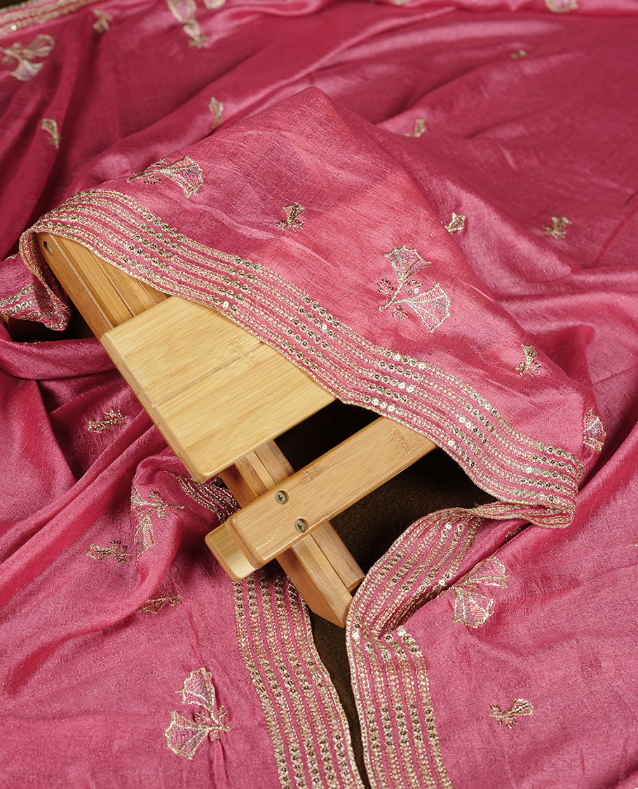 Pink colour churidar material with subtle mirror and thread embroidery, finished with delicate border detailing and paired with a matching plain bottom and dupatta.