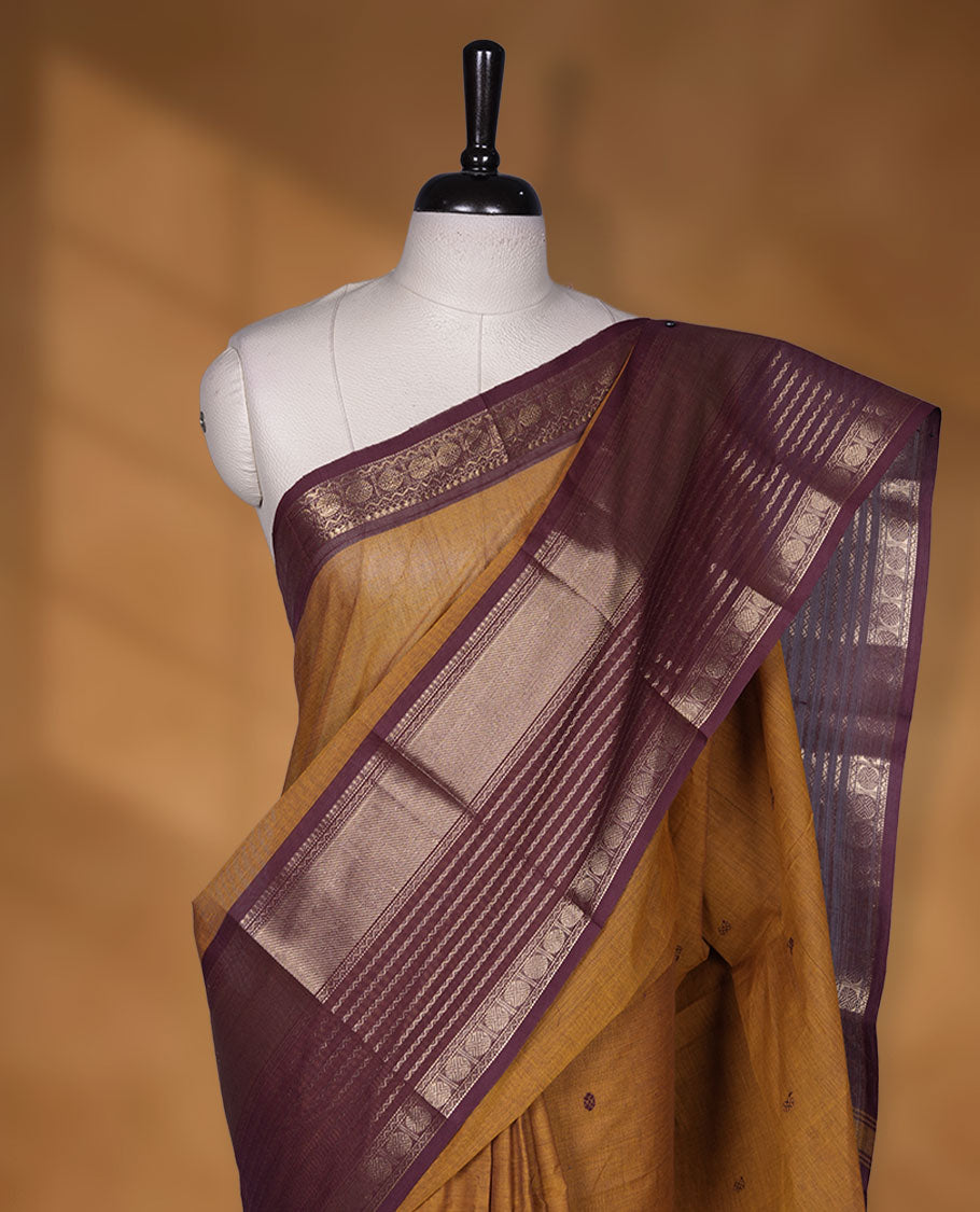 Mustard colour chettinad cotton saree featuring maroon colour motifs on body, contrast maroon colour border with gold zari border, pallu and paired with matching blouse