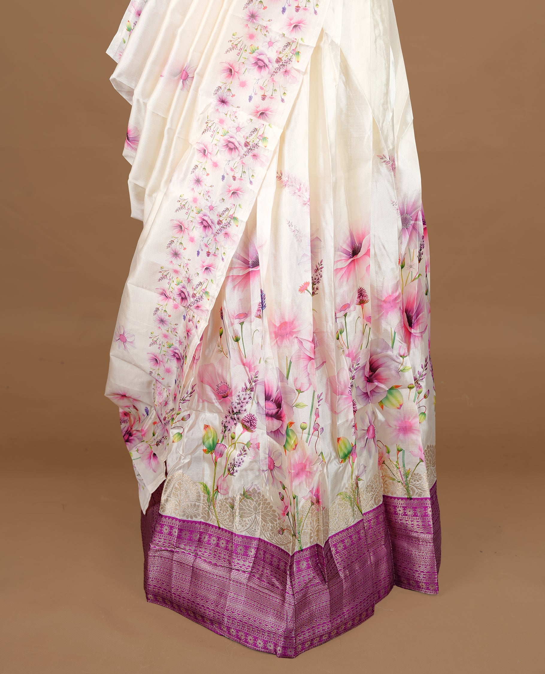 Off white colour semi stitched half saree featuring elegant multicolour floral prints, paired with a light gold border and matching printed dupatta ,paired with matching blouse piece.