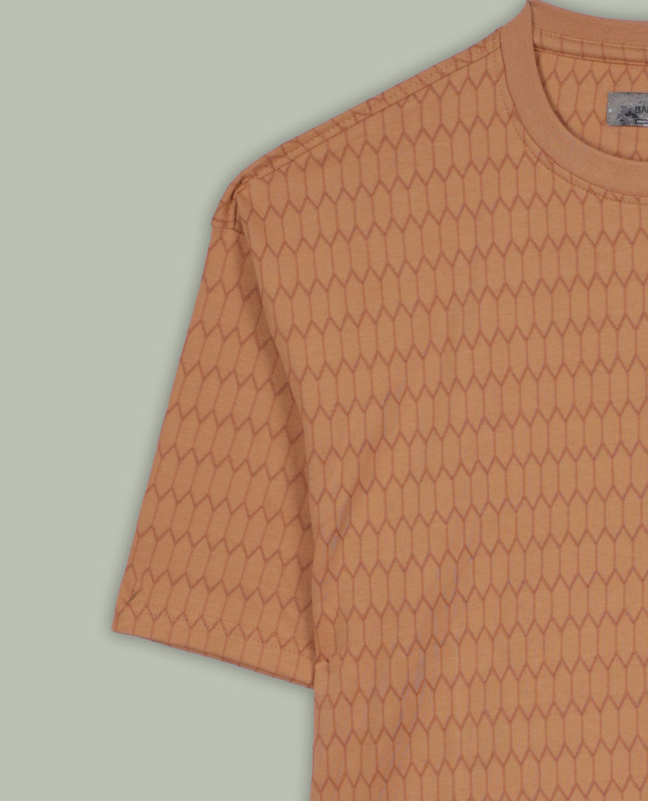 Pastel orange colour T shirt featuring a honeycomb textured pattern, designed with a classic round neck and short sleeves, made from soft breathable fabric for a relaxed and stylish everyday look.