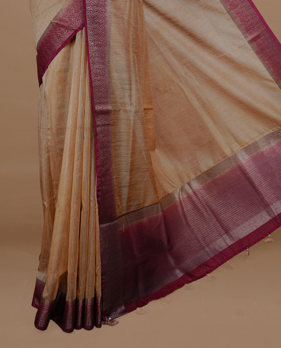 Beige colour Semi linen saree featuring Elegant plain body, complemented by contrast Maroon colour With Antique zari border, paired with matching blouse piece.