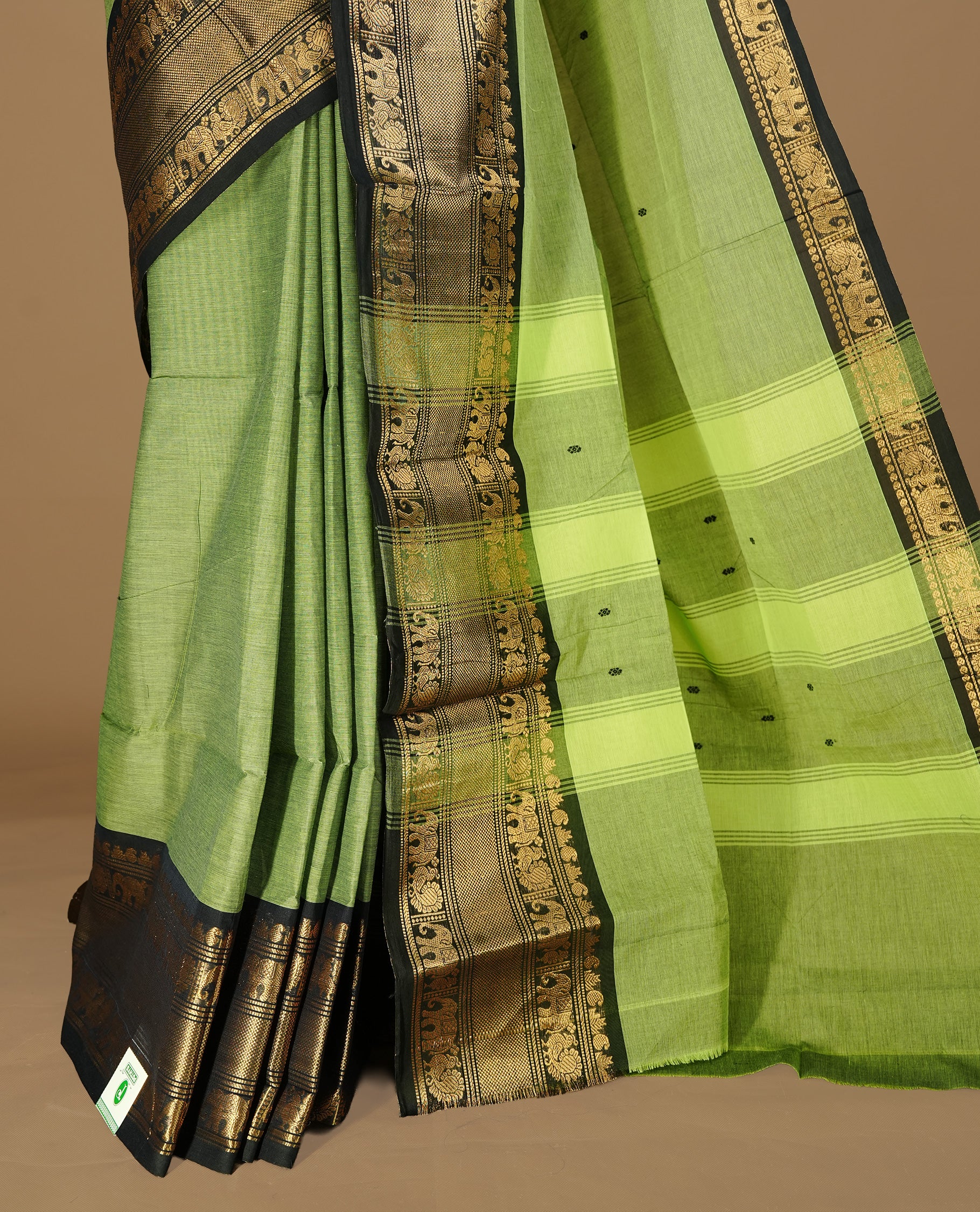 Green colour Chettinad cotton saree featuring motif on body, complemented by Black colour with traditional border, paired with matching blouse Piece.