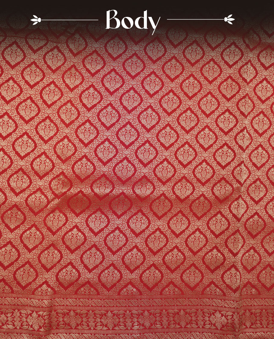 Red colour banaras satin crepe saree featuring gold zari pattern across body, with self colour border with gold zari pattern and paired with matching blouse.