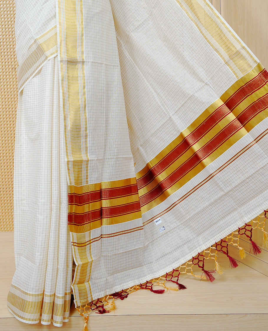 Cream colour Cotton kerala saree featuring Gold zari Checks on body, complemented by Gold zari border & Maroon with gold zari Pallu, paired with matching blouse piece.