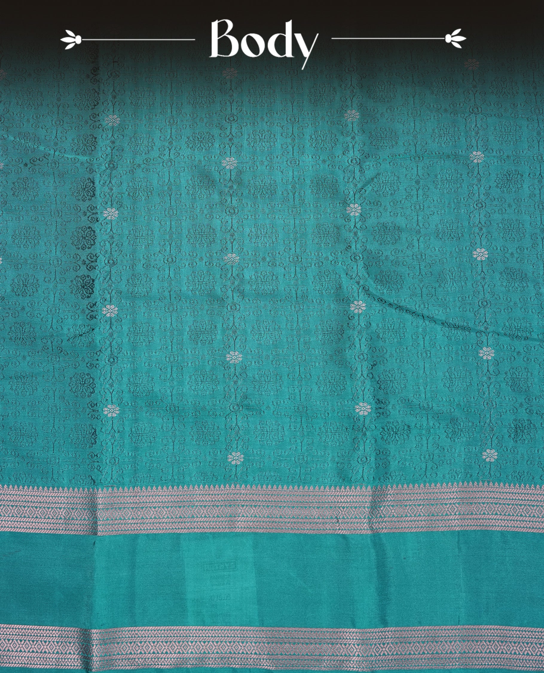 Teal Green Colour Semi Soft Slik Saree Featuring An Elegant Self Floral Woven Body, Enhanced By A Traditional Rose Gold Zari Border And Rich Pallu, Paired With A Matching Blouse Piece.