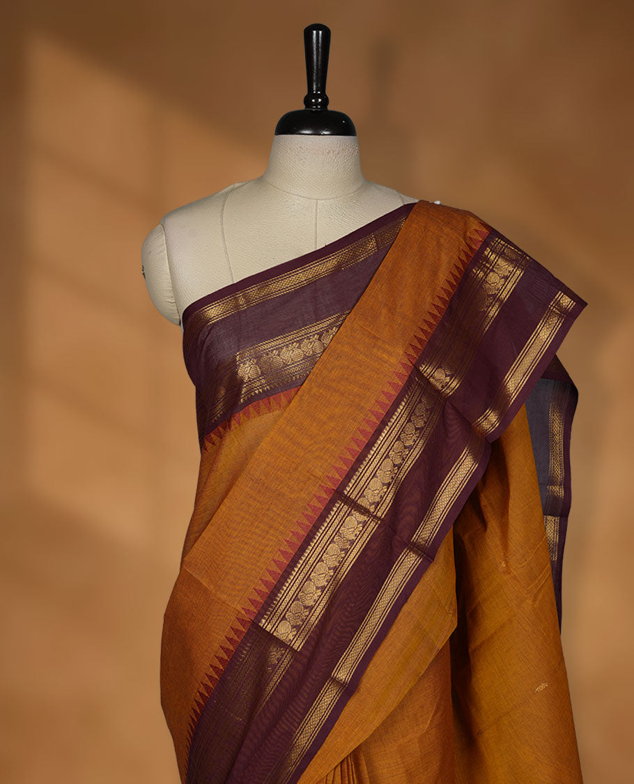 Mustard colour chettinad cotton saree featuring Purple colour motifs on body, contrast maroon colour border with gold zari temple border, pallu and paired with matching blouse