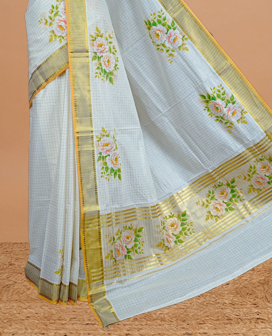 Cream Colour Kerala Saree Featuring Gold Zari Checks On The Body, Enhanced By A Gold Zari Border With Floral Prints And A Matching Pallu, Paired With A Matching Blouse Piece.
