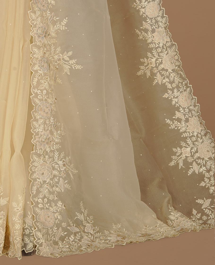 Pastel yellow colour organza saree featuring thread with cut beats & sequins floral pattern on body, highlighting scalp border, paired with matching blouse piece.