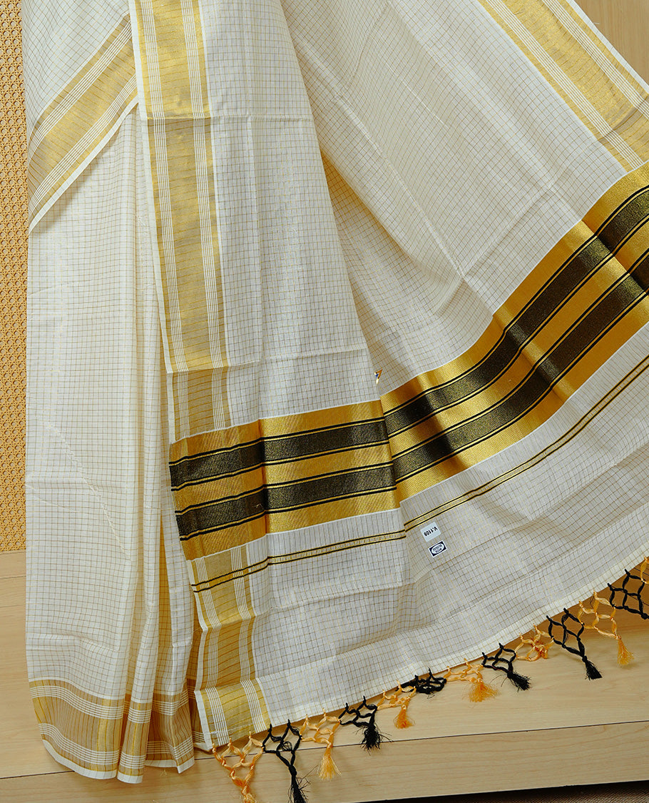 Cream colour Cotton kerala saree featuring Gold zari Checks on body, complemented by Gold zari border & Black with gold zari on Pallu, paired with matching blouse piece.