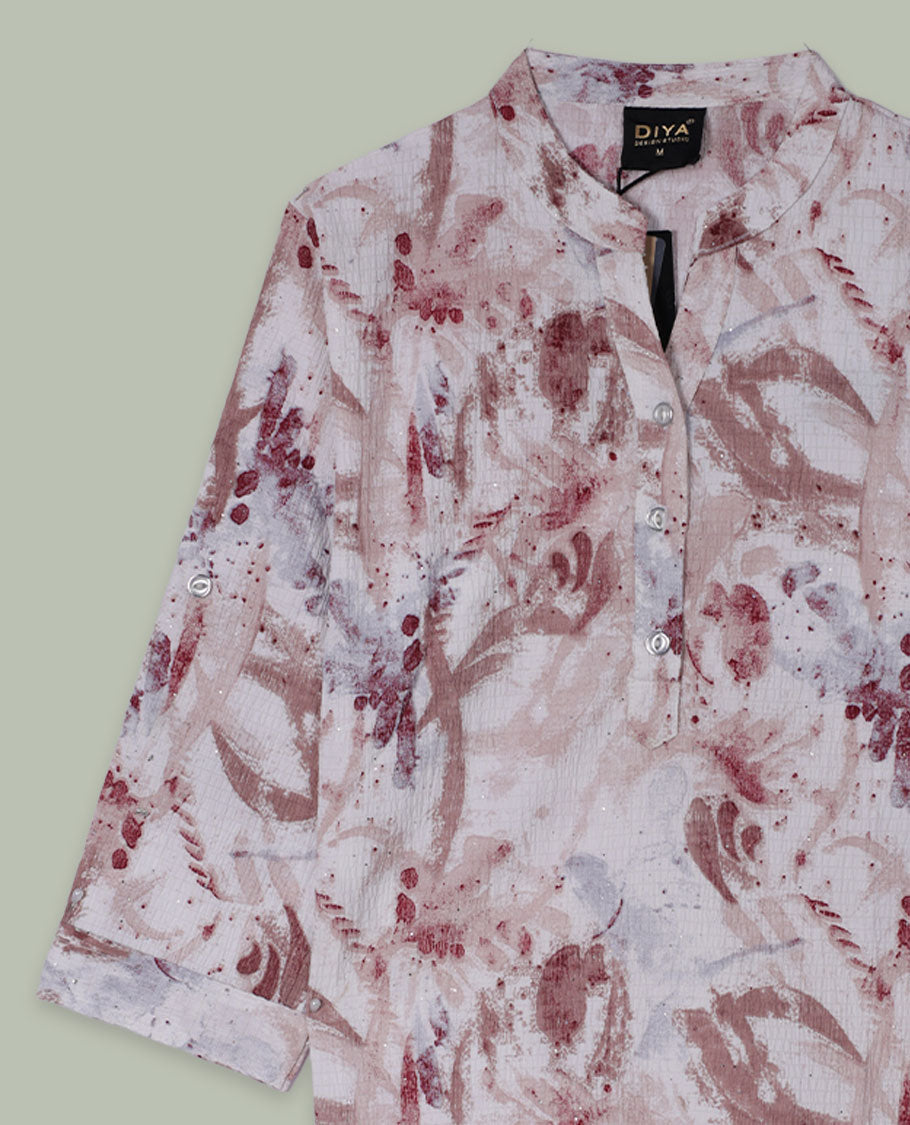 Blush and beige abstract printed tunic top with band collar, half button placket, three-quarter sleeves, and curved hem.