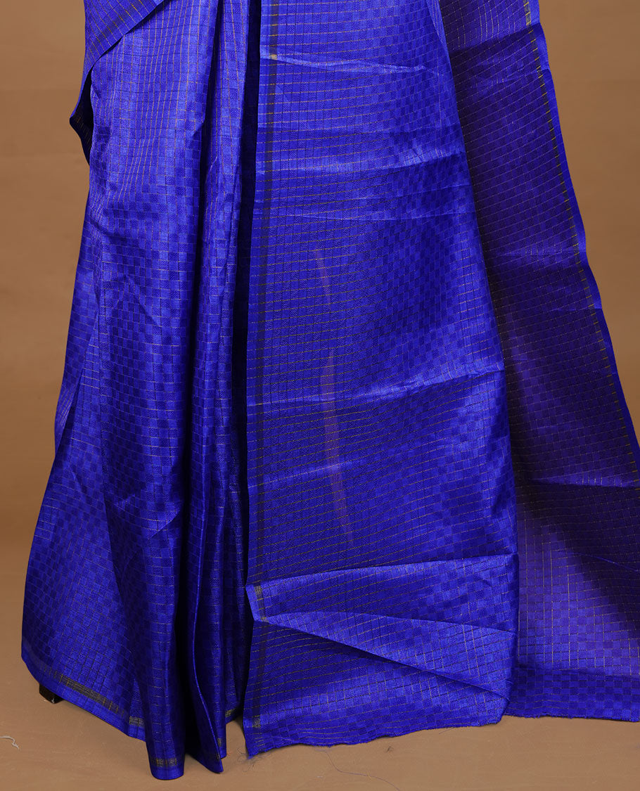 Blue colour Semi Tussar saree featuring an elegant zari fancy check pattern on the body, highlighted with a small border for a refined look. Comes without a blouse piece.