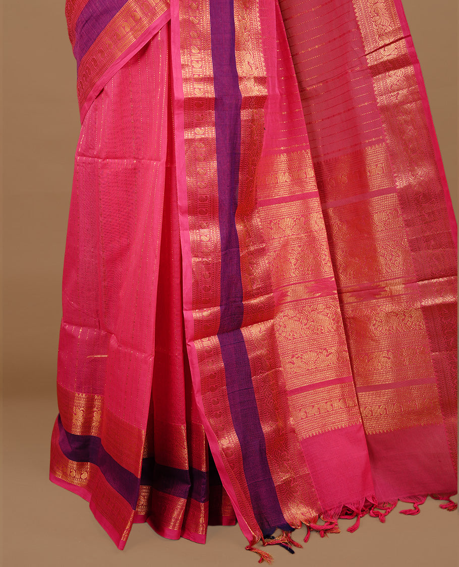 Magenta colour chettinad cotton saree featuring gold zari stripes on body, complemented by purple colour with zari border, paired with matching blouse piece.
