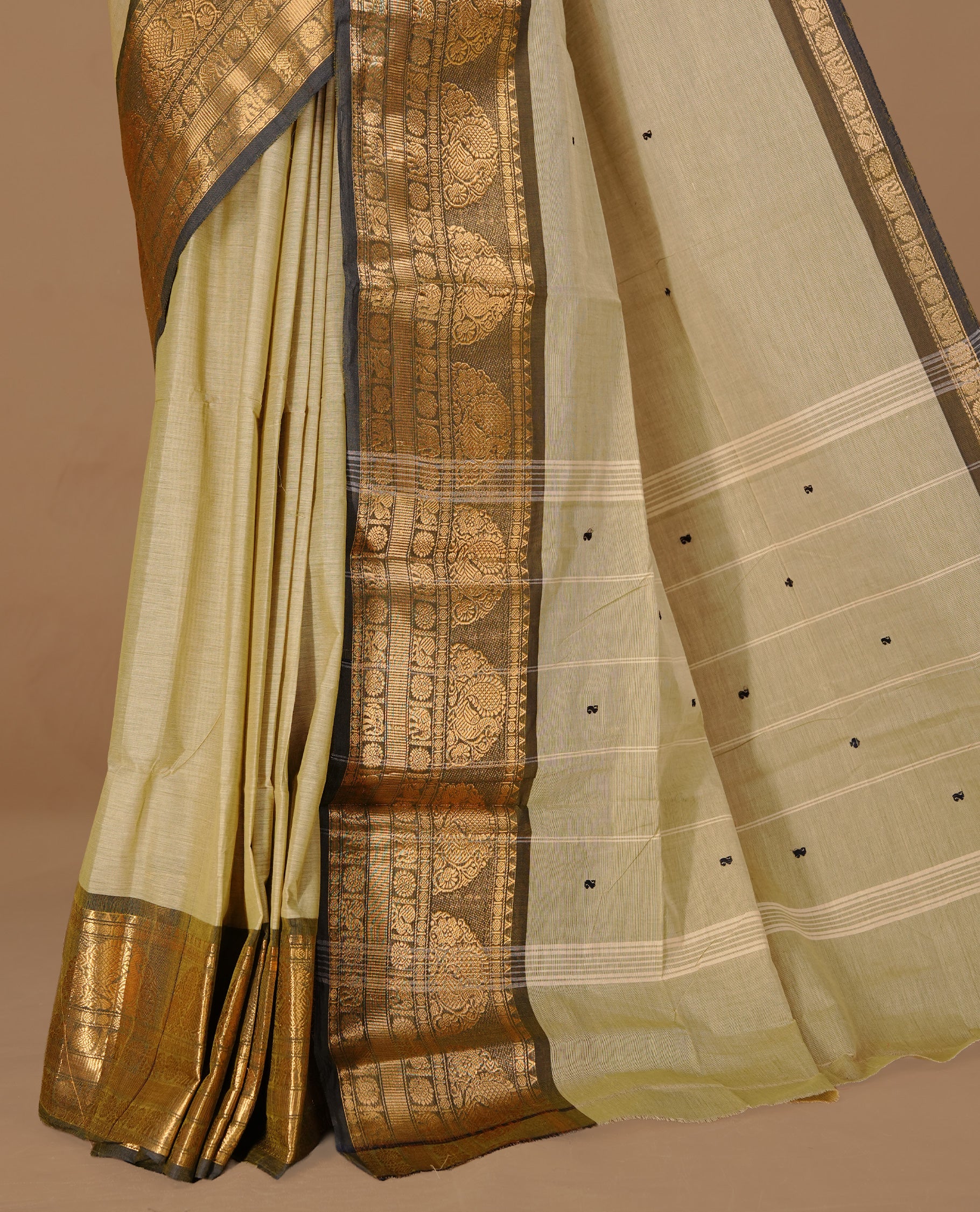 Grey beige colour Chettinad cotton saree featuring motifs on body , complemented by contrast Black colour with zari border, comes with matching blouse piece.