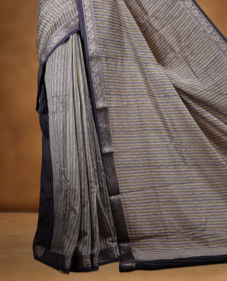 Cream colour chanderi silk saree with ash & olive geometric stripped printed On body, compilmented by contrast Dark ash colour border with golden zari floral pattern and a matching blouse.