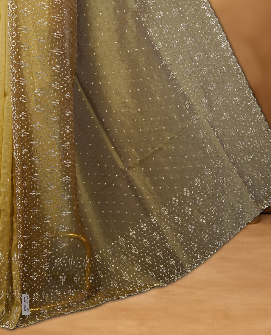 Gold Colour Shimmer Designer Saree featuring Delicate gold Stone Scattered Work on the Body, enhanced with Intricate Stone Detailing on the Border and Pallu, paired with a Matching Blouse.