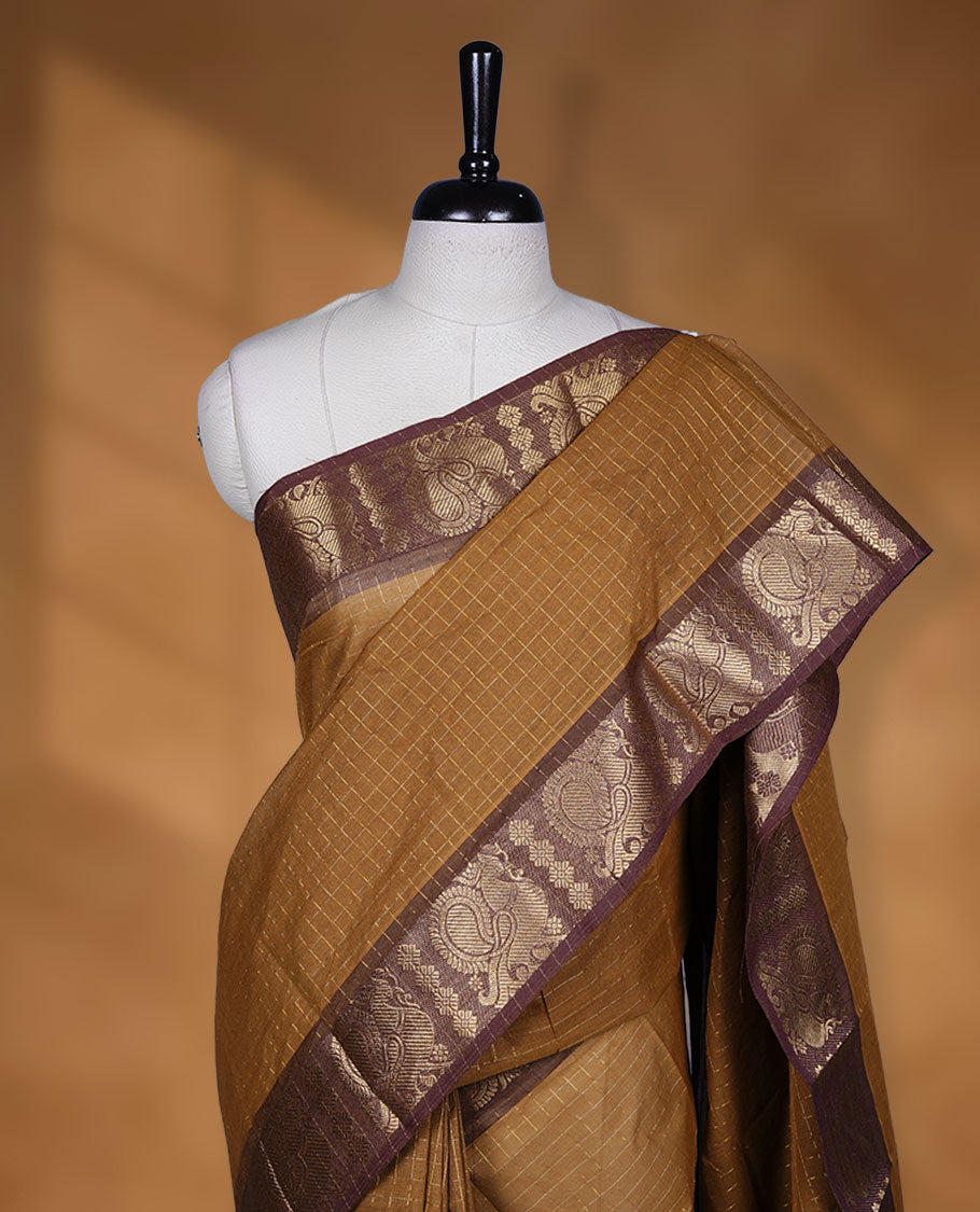 Goldenrod colour sungudi cotton saree featuring gold zari check pattern across body, contrast Brown colour with gold zari peacock pattern on border, without blouse piece.