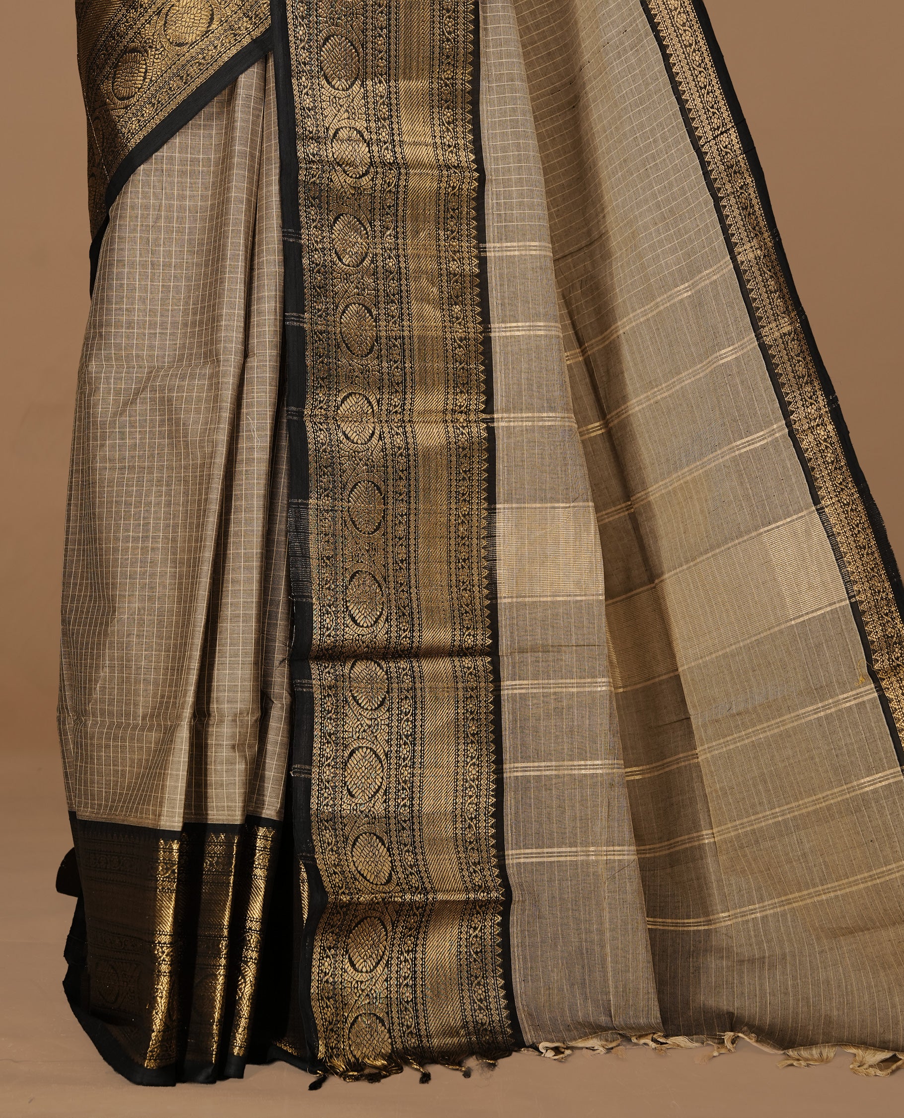 Grey Beige colour Chettinad cotton saree featuring Check pattern on body , complemented by contrast Black colour with zari border, comes with matching blouse piece.