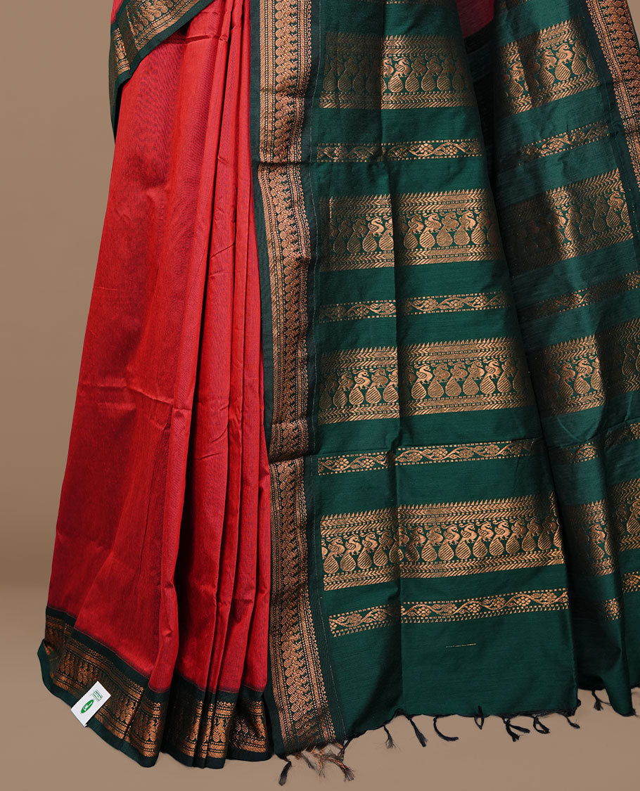 Red colour kalyani cotton saree featuring antique zari motifs on body, complemented by Green colour with Antique zari border, paired with matching blouse piece.