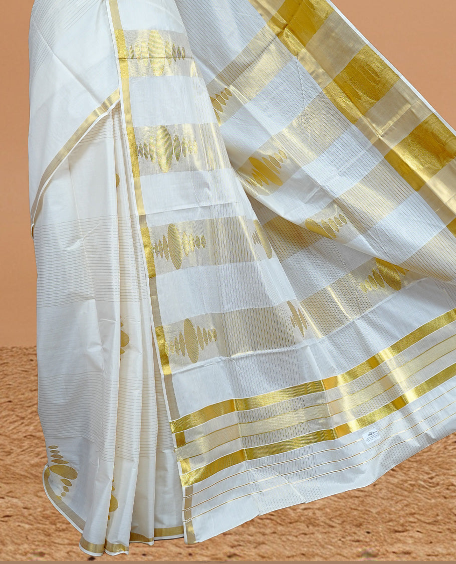Cream Colour Kerala Saree Featuring Gold Strips On The Body, Complemented By A Gold Zari Circle Pattern On Border, Paired With A Matching Blouse Piece.