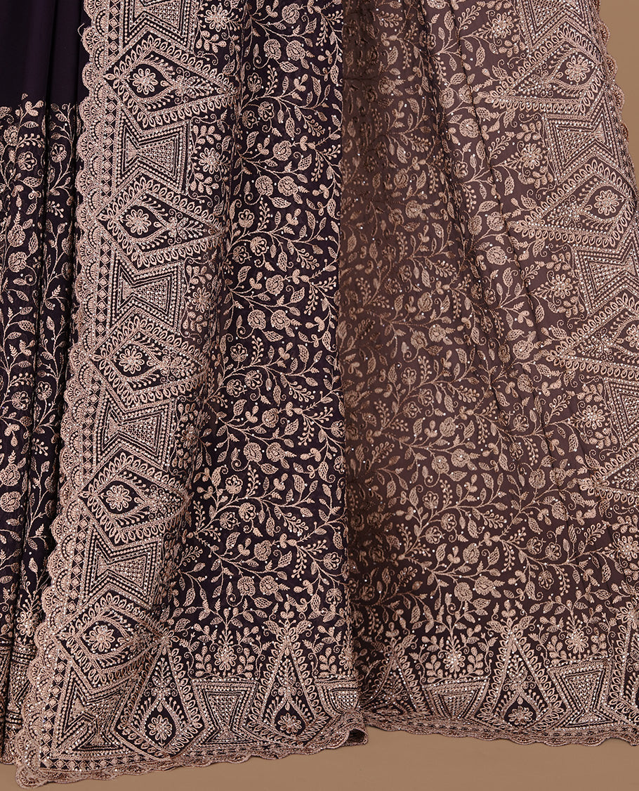 Deep purple colour georgette designer saree featuring Gold thread floral pattern on body highlighting with stone and scalp border, paired with matching blouse piece.