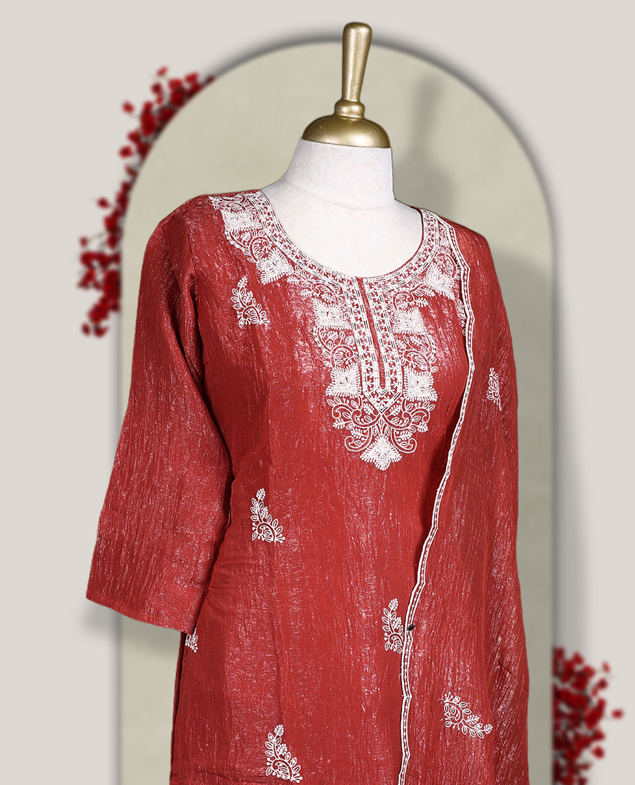 Orange colour churidar set featuring elegant white thread embroidery on the neckline, sleeves, and scattered motifs across the body, Paired with a matching embroidered dupatta, this ensemble radiates graceful charm and festive appeal.