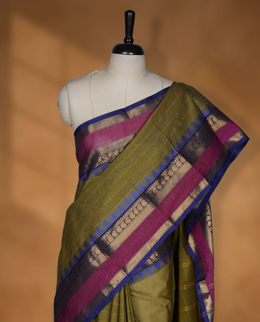 Olive colour chettinad cotton saree featuring stripes on body highlighting contrast magenta and blue with gold zari border, pallu and paired with matching blouse piece.