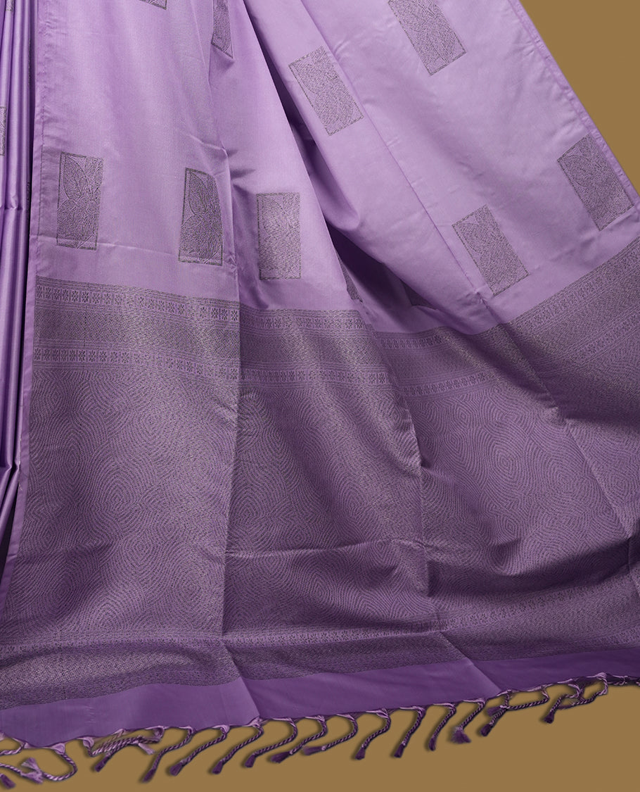 Lavender semi soft silk saree featuring woven rectangular motifs on the body, elegant woven border, and rich matching pallu with tassel finish & Comes with a coordinating blouse piece for a graceful look.