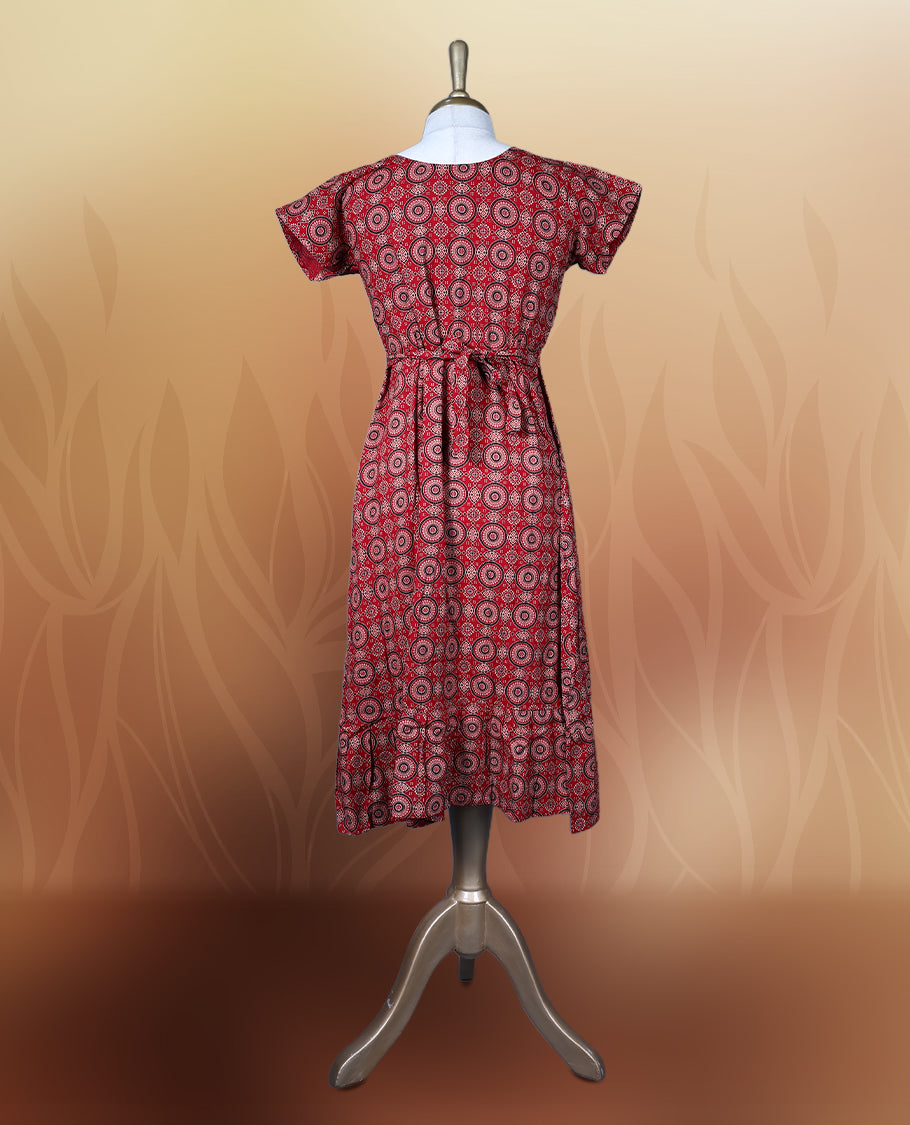 Red colour nightwear with intricate circular patterns in beige and black, Designed with a V neckline, short sleeves, and a flared hemline. Ideal for casual outings, workwear, or ethnic inspired looks.