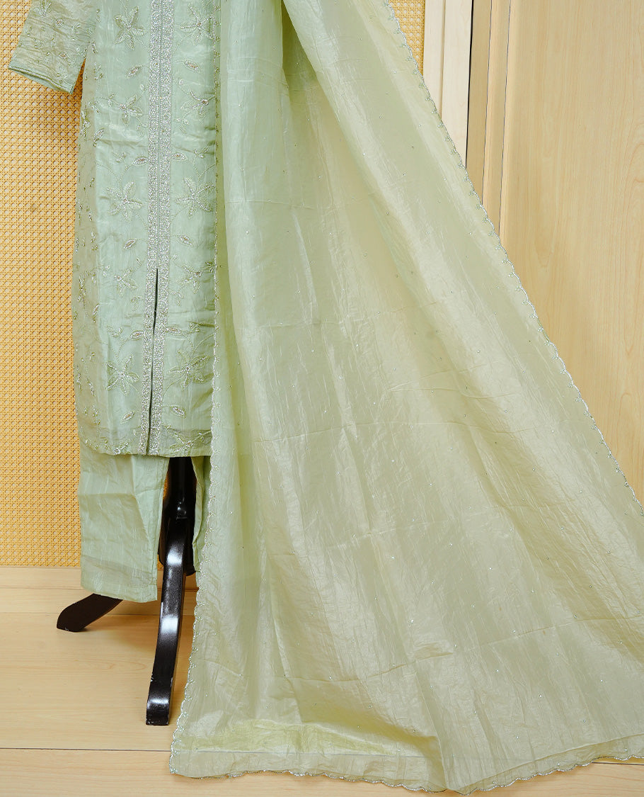 Pastel green colour churidar set with floral Stone & thread embroidery work on the V-neckline, paired with a matching embellished dupatta and solid pants.