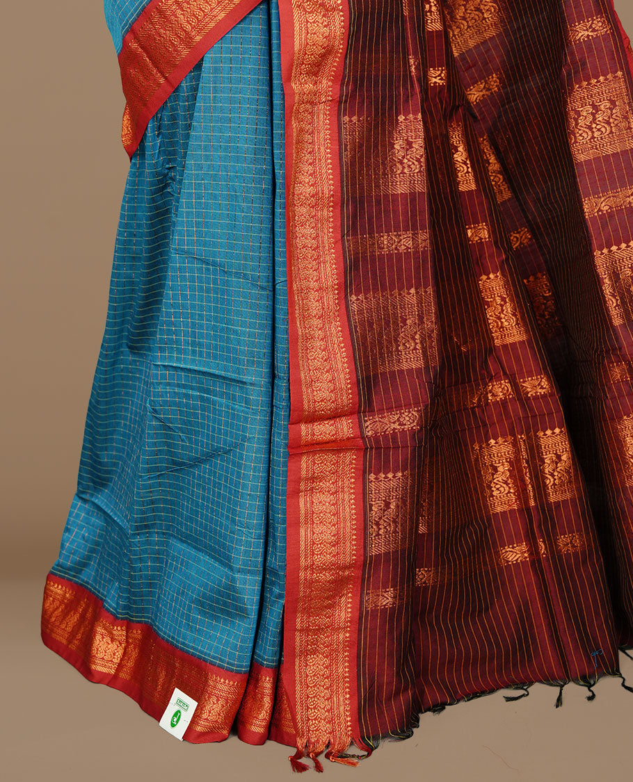 Blue colour kalyani cotton saree featuring gold zari check pattern on body, complemented by Maroon colour with Antique zari border, paired with matching blouse piece.