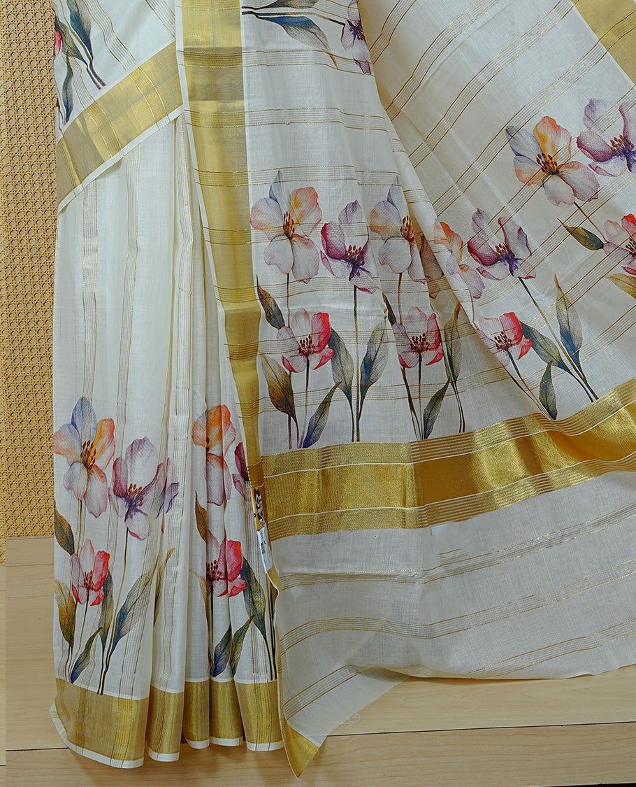 Cream Colour Cotton Kerala Sree Featuring Gold Zari Stripes On Body, Enrich Gold Zari With Floral Printed Border & Pallu, Paired With Matching Blouse Piece.
