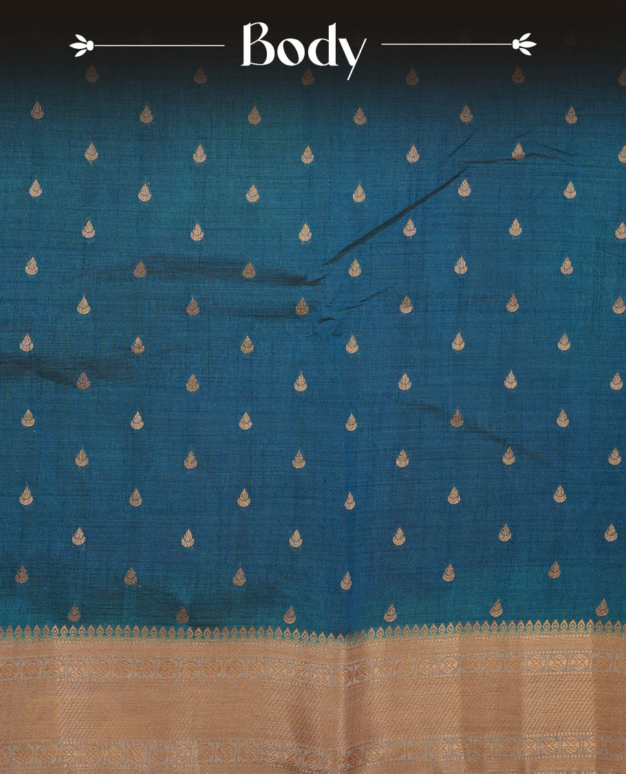 Teal colour semi tussar saree featuring gold zari buttas across body, contrast grey colour gold zari border and comes with matching blouse piece.