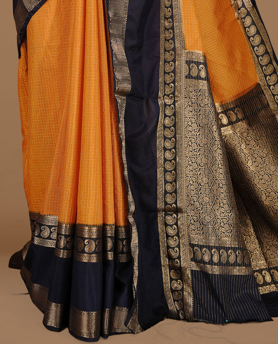 Mustard colour semi georgette saree featuring gold zari check pattern on body, complemented by contrast Blue colour with zari border, paired with matching blouse piece.
