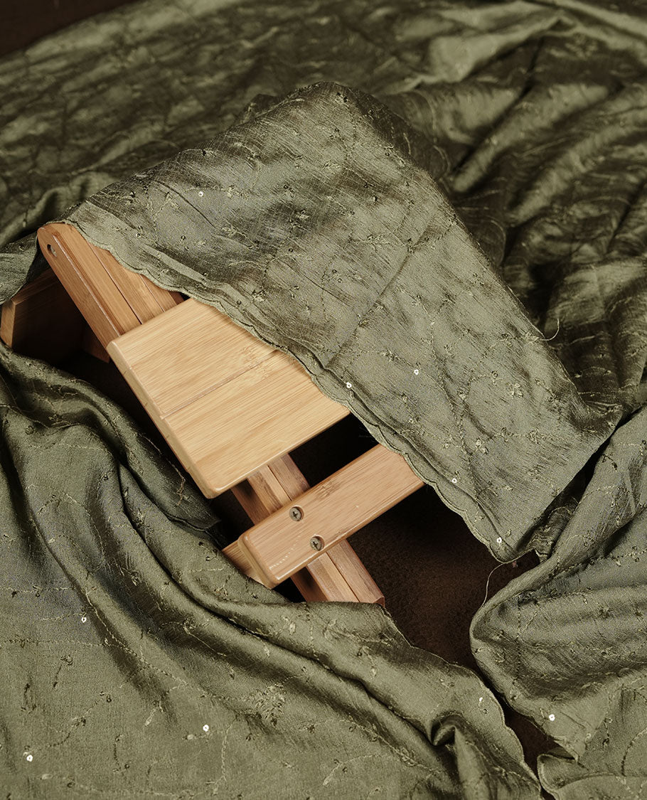 Ivory colour churidar material with sage green colour thread embroidery on the front panel, paired with a matching dupatta and bottom.