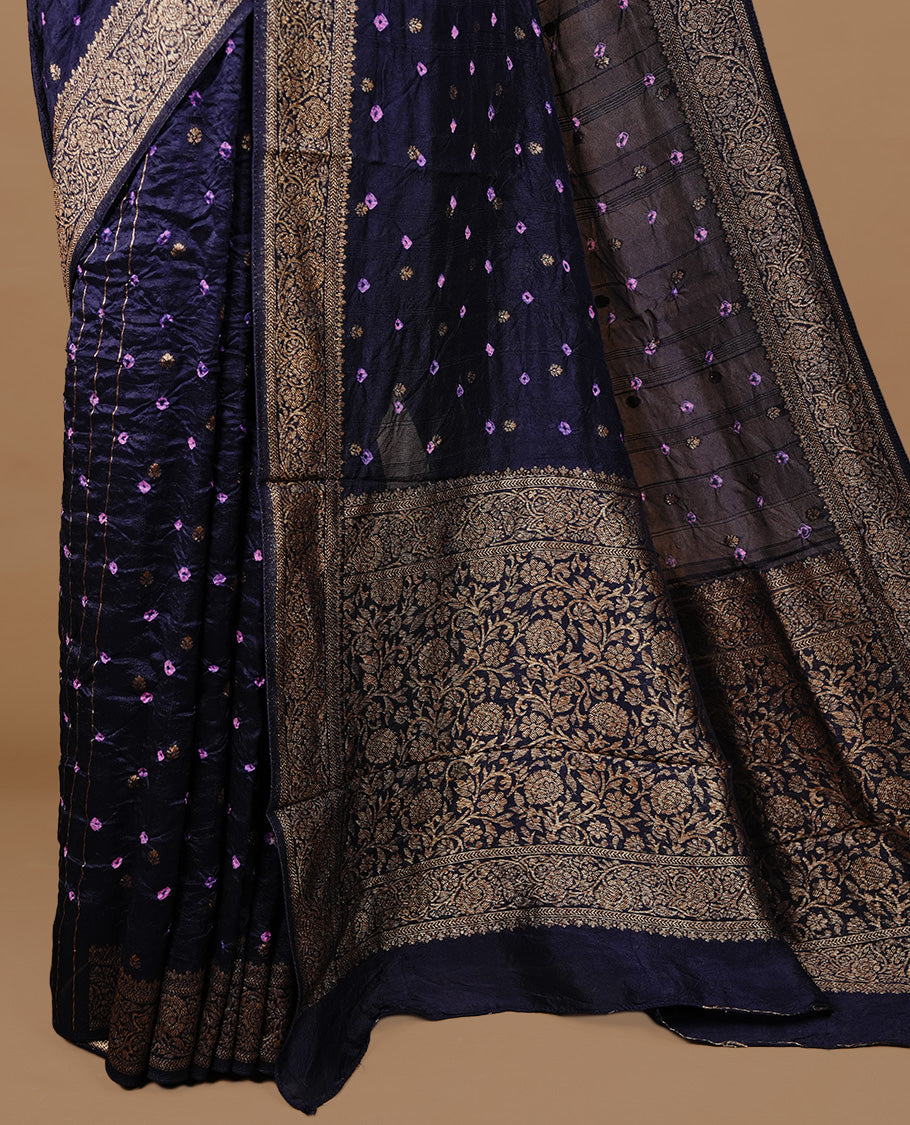 Dark purple colour Banarasi Bandhani silk saree featuring intricate antique zari circle Buttas across the body, complemented by an elegant antique zari border. Comes paired with a matching blouse piece
