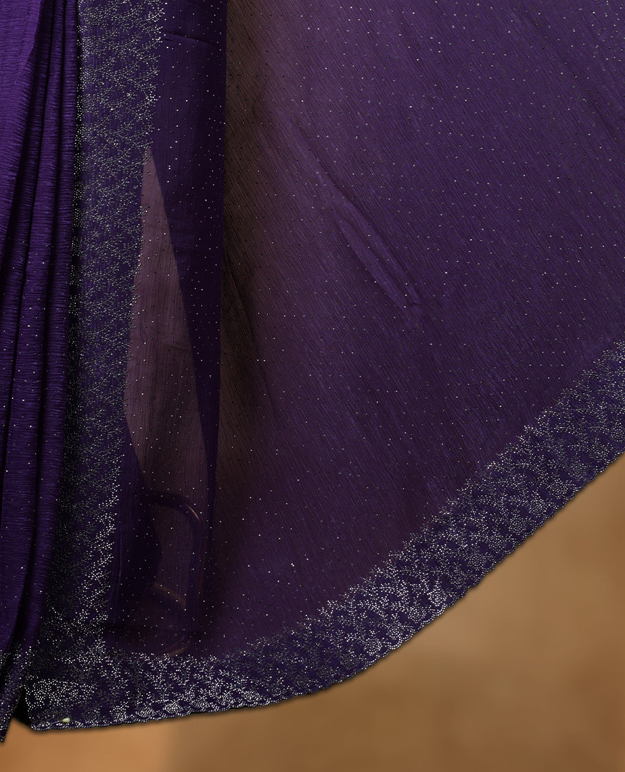 Violet colour chiffon designer saree, featuring white stone all over on body, heavy stone patttern on border and pallu, Paired with matching blouse.