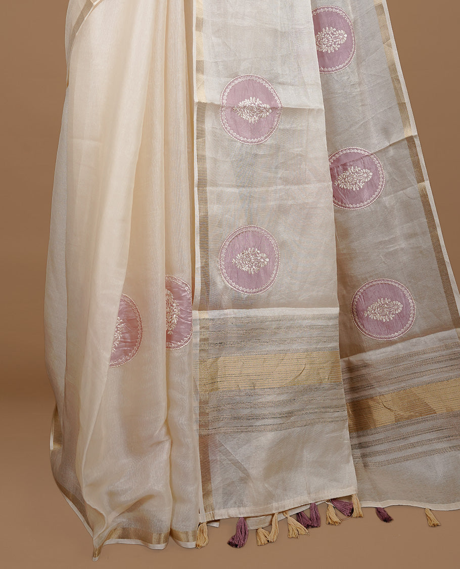 Cream colour Tussar saree featuring mauve colour circle pattern with chikankari embroidery work, highlighting gold zari simple border, paired with matching unstitched blouse.