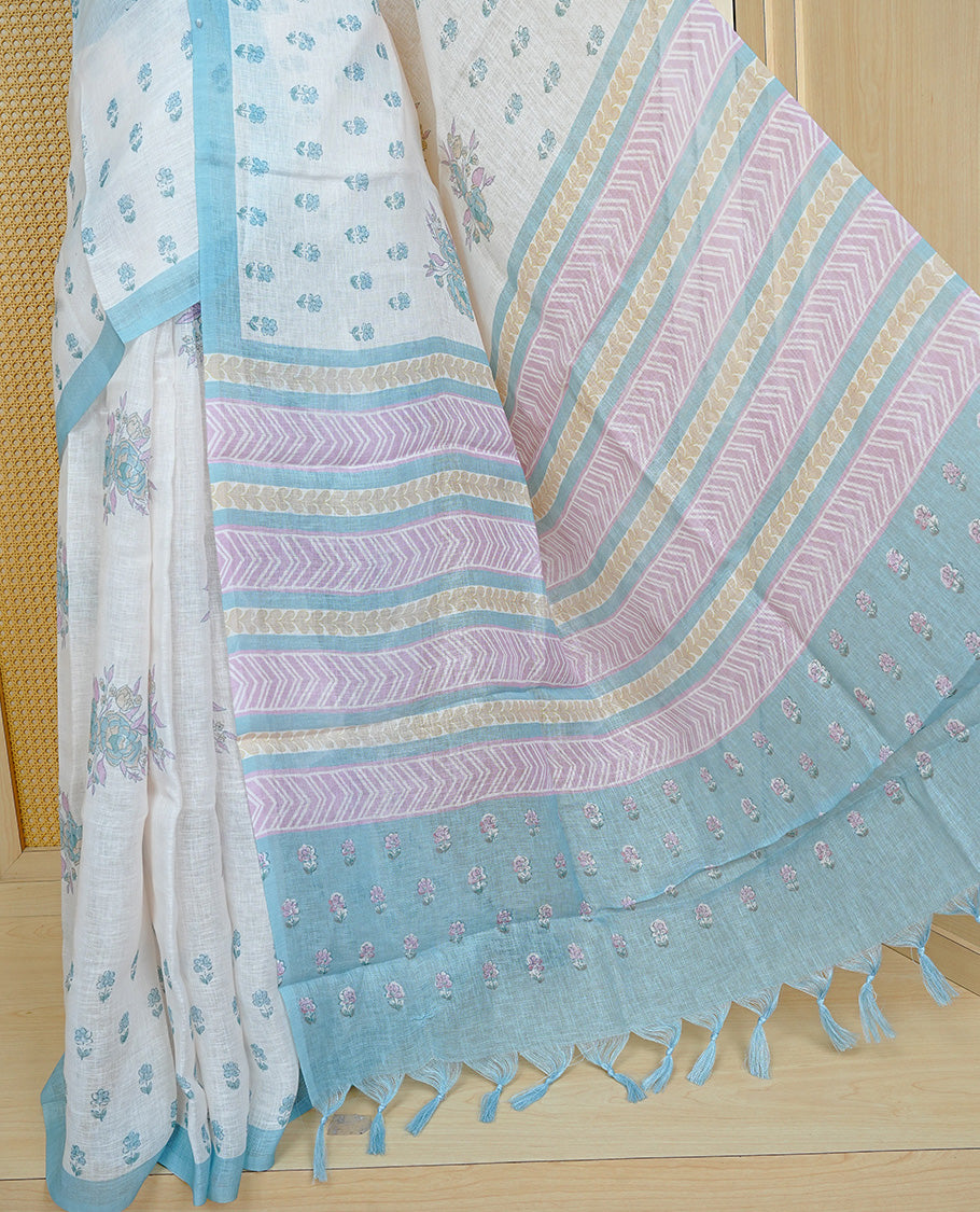 Cream colour semi linen saree featuring Floral printed buttas on body, complemented by contrast Blue colour border, comes with matching blouse piece.