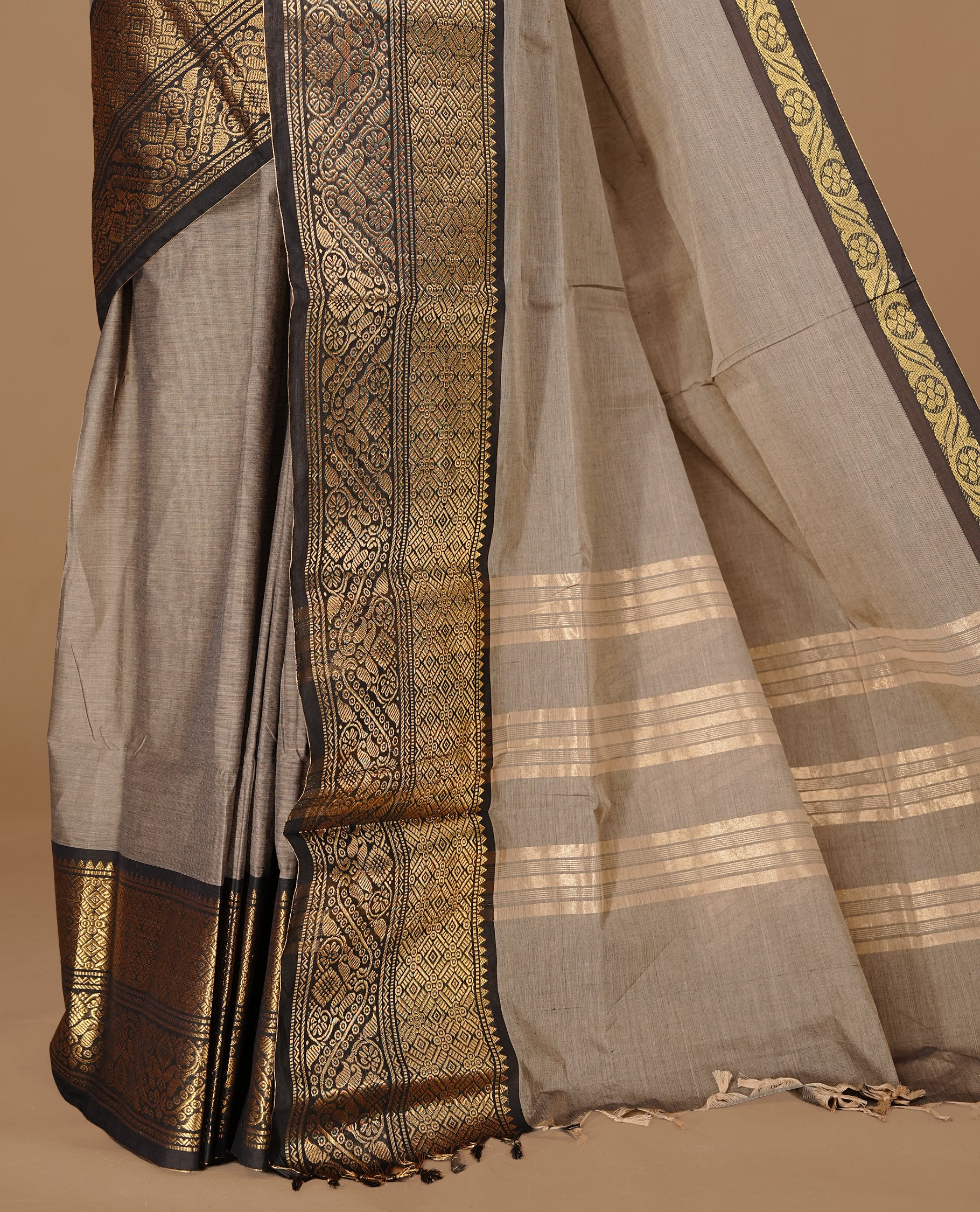 Grey Beige Colour chettinad cotton saree featuring Elegant plain body, complemented by contrast Black colour with gold zari border, paired with matching blouse.
