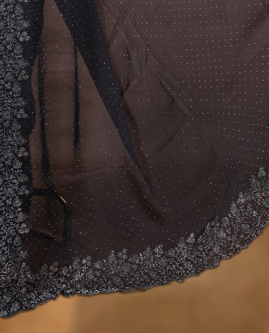 Black colour shimmer designer saree, featuring white scattered stone on body, stone work and heavy stone floral pattern on border and pallu, Paired with matching blouse.