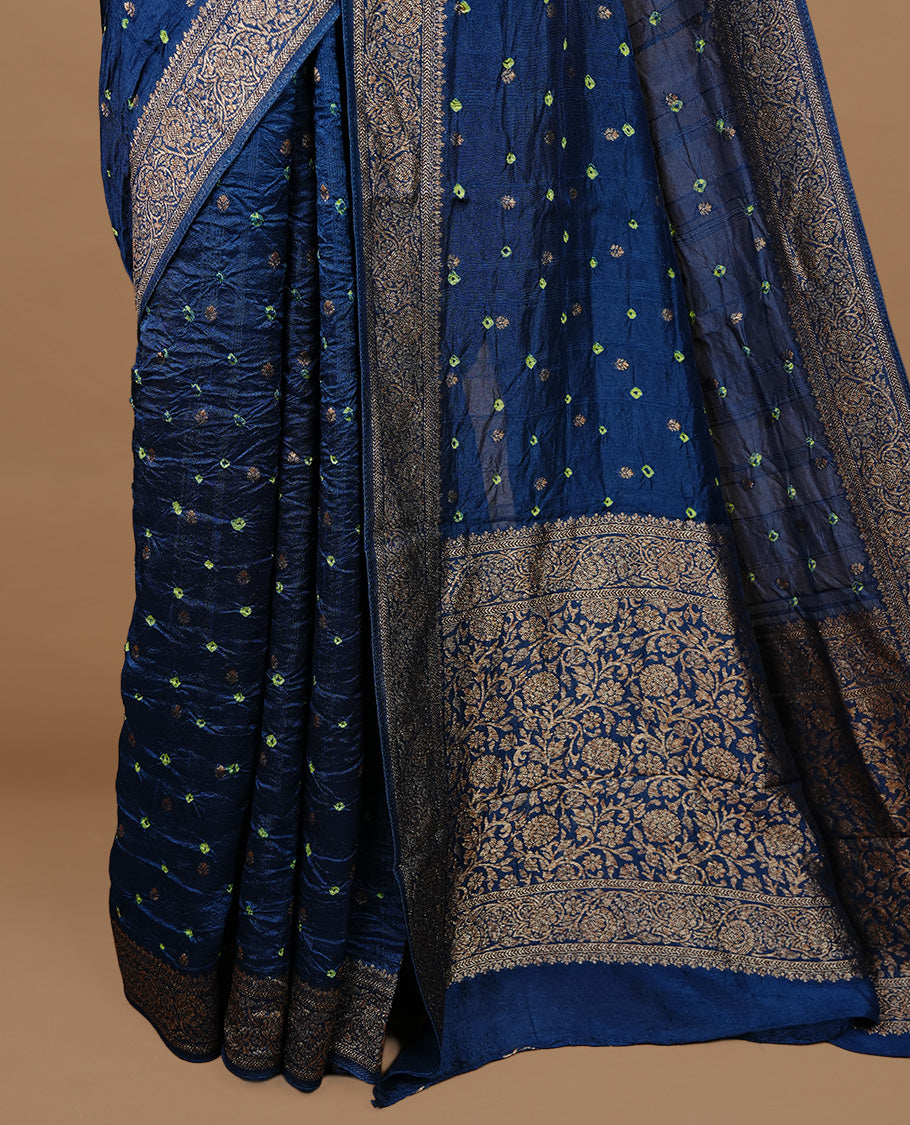 Persain Blue colour Banarasi Bandhani silk saree featuring intricate antique zari circle Buttas across the body, complemented by an elegant antique zari border. Comes paired with a matching blouse piece