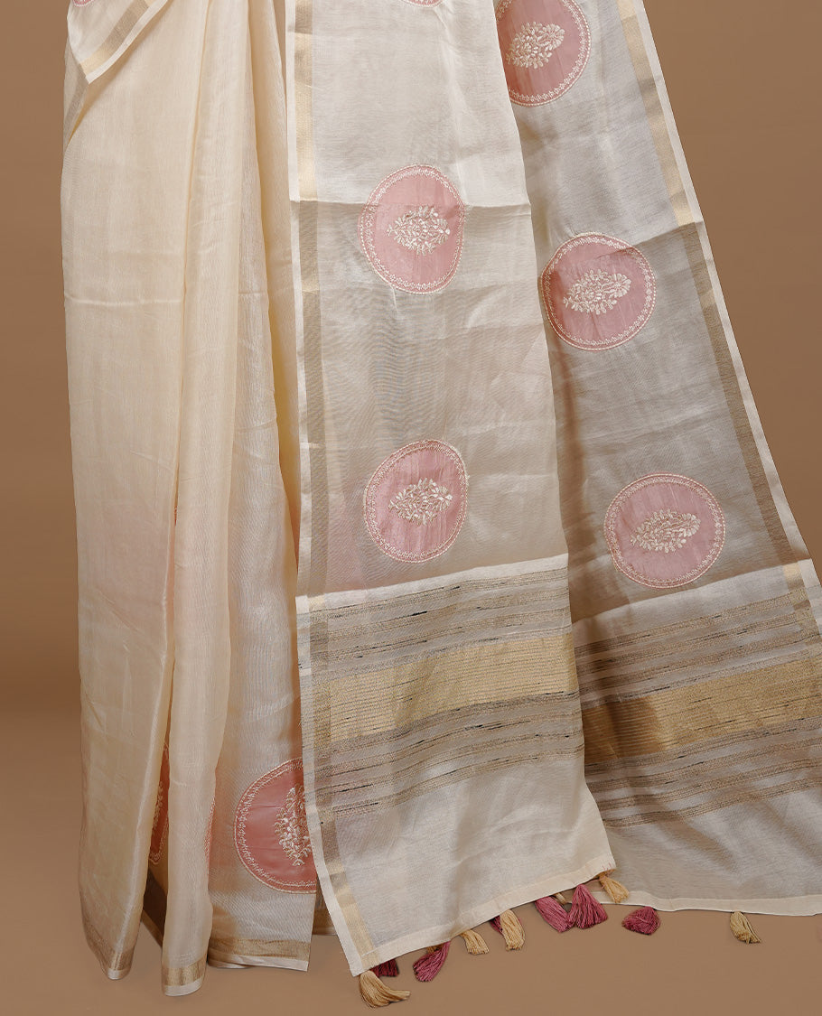 Cream colour Tussar saree featuring pink colour circle pattern with chikankari embroidery work, highlighting gold zari simple border, paired with matching unstitched blouse.