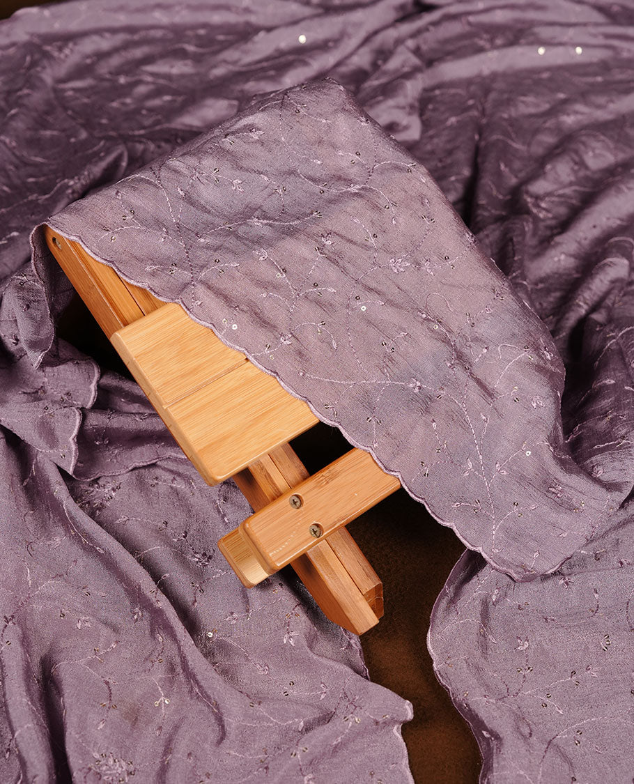 Ivory colour churidar material with lavender colour thread embroidery on the front panel, paired with a lavender matching dupatta and bottom.