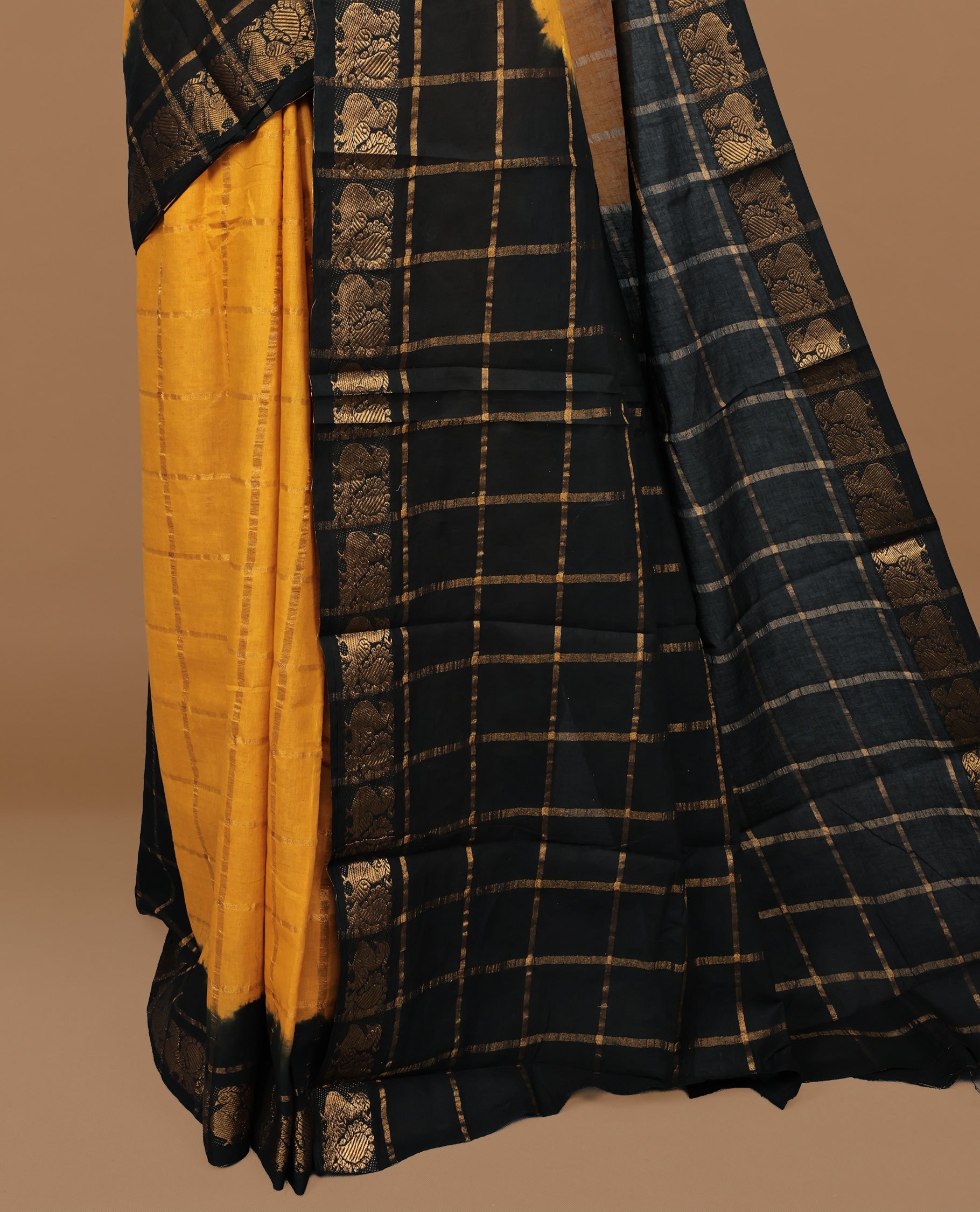 Mustard colour Sungudi cotton saree featuring Gold zari Check pattern on body, Gold zari Peacock design on Dyed Black colour design border, paired with matching blouse piece.