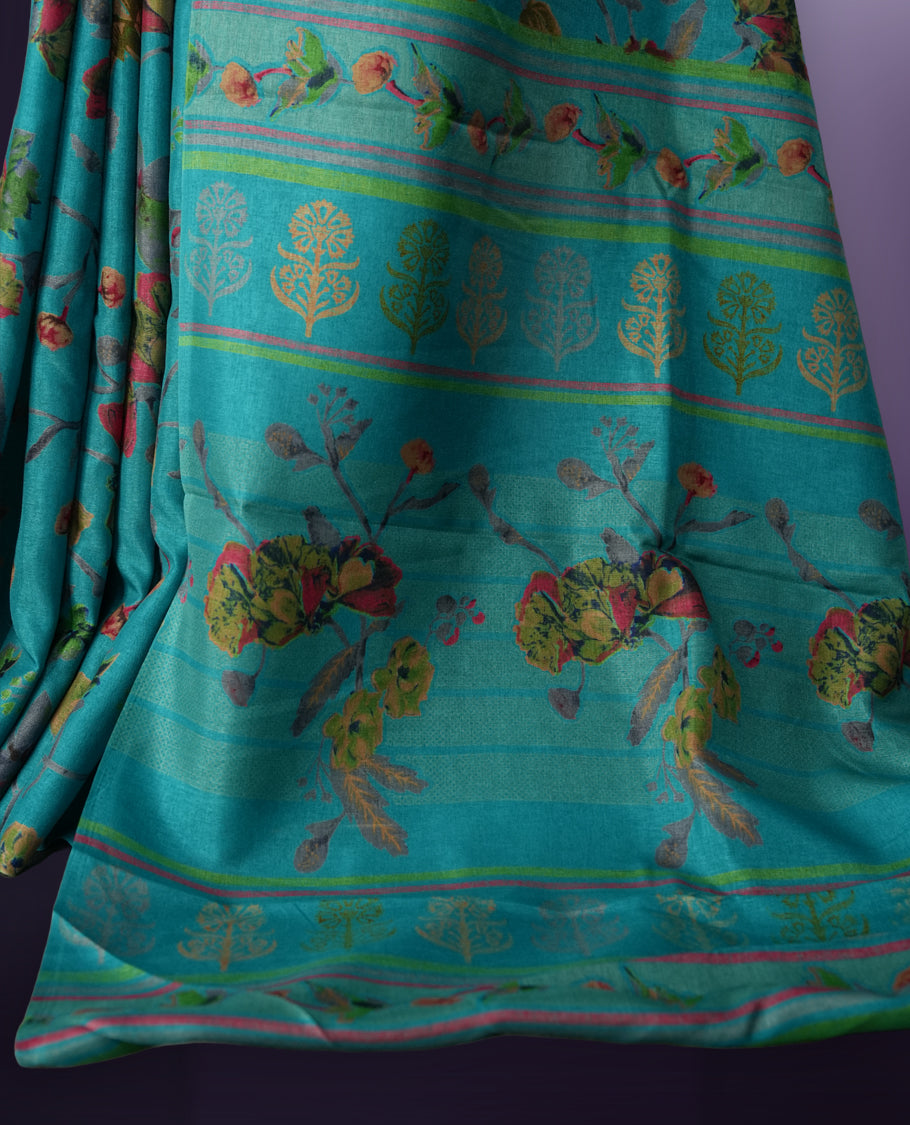 Turquoise Blue colour saree enhanced with a vibrant olive green,maroon and grey colour floral prints on body & pallu, and comes with a matching blouse.