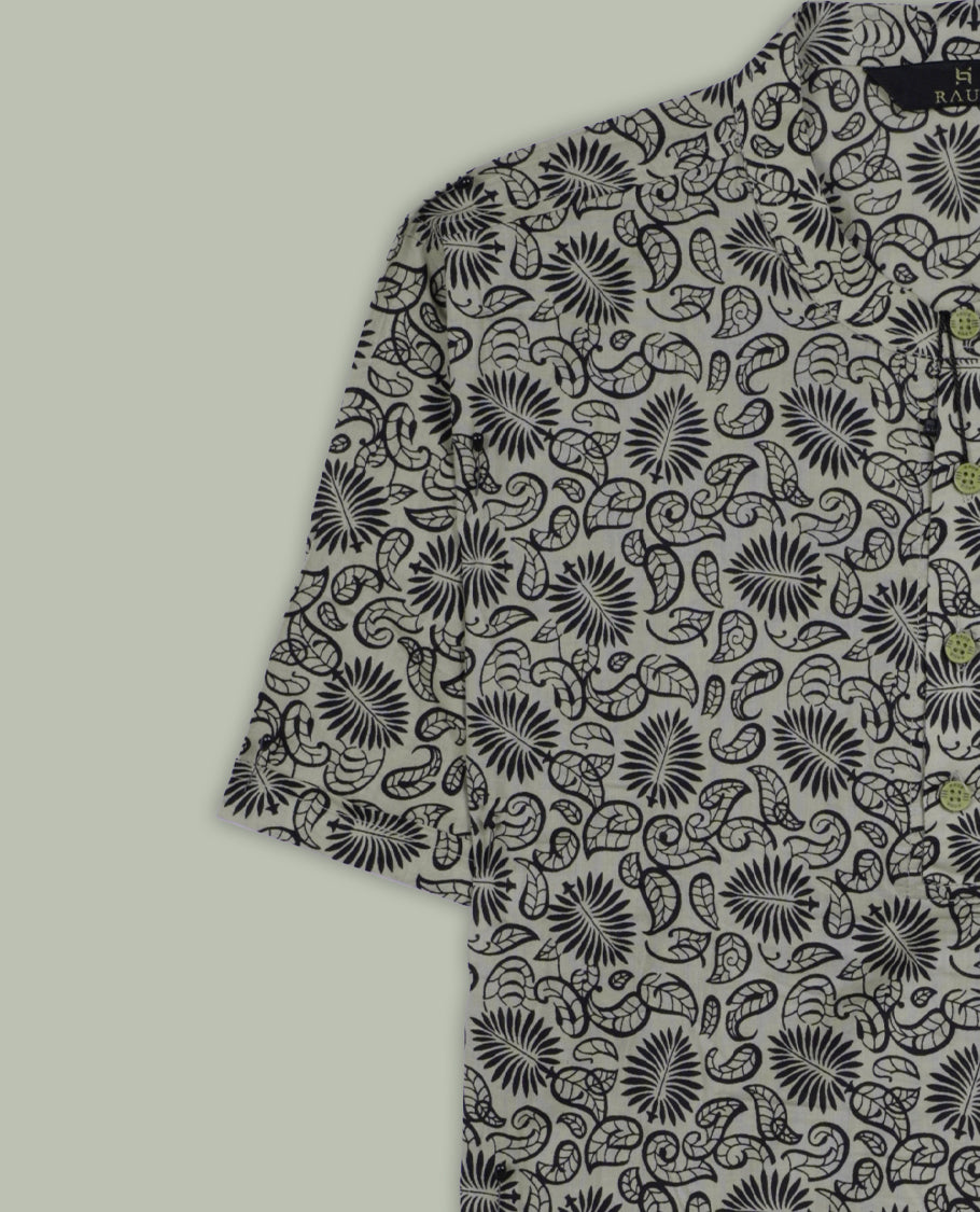 Beige colour short sleeve shirt with black floral and paisley print, featuring a classic chinese collar and wooden button half placket, A breezy and stylish pick for both relaxed days and casual evenings.
