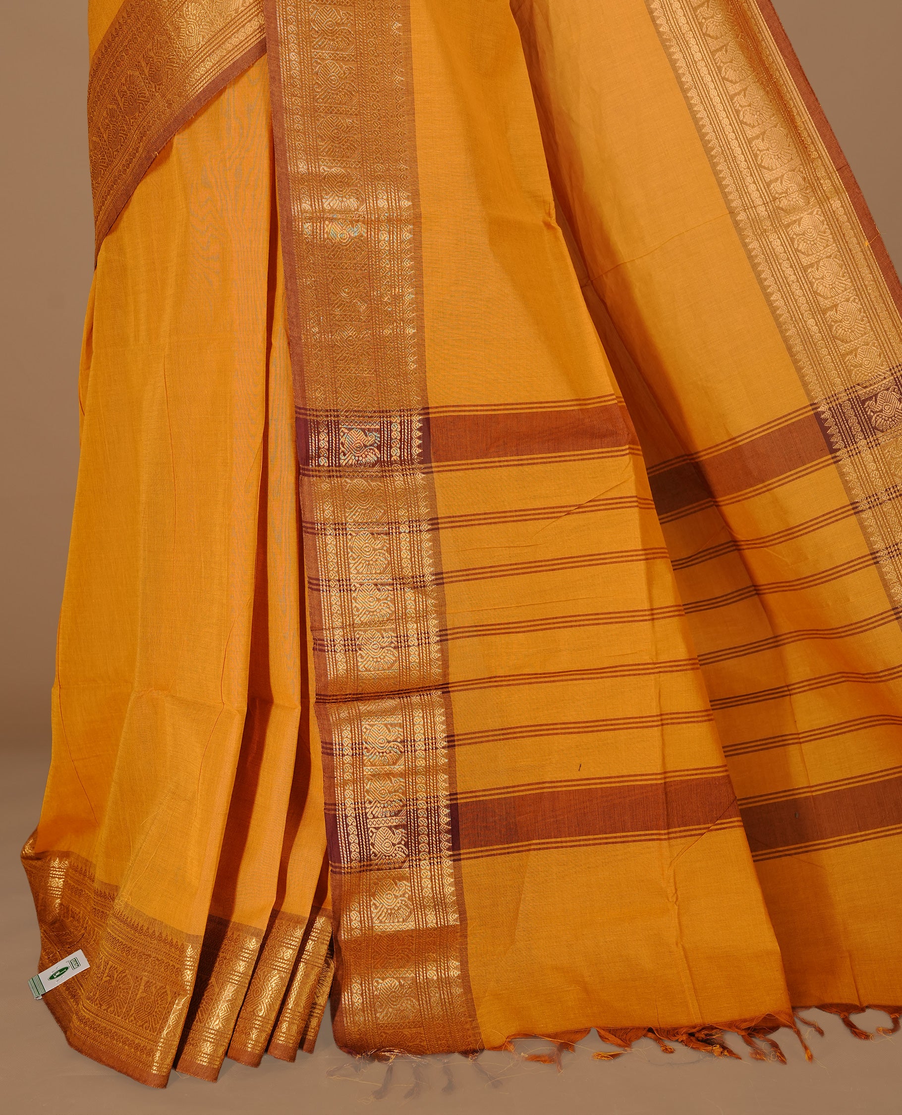 Mustard colour Chettinad cotton saree featuring Elegant plain body, complemented by contrast Light Brown colour with gold zari border, paired with matching blouse piece.