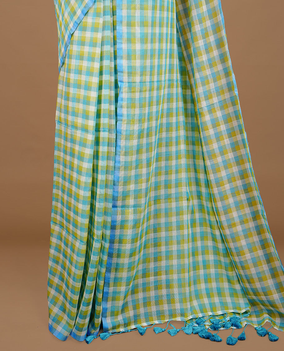 Blue, Green and White colour Mul Cotton saree featuring a classic Big check pattern on the body, accented with tassels for added charm. Comes without a blouse piece.